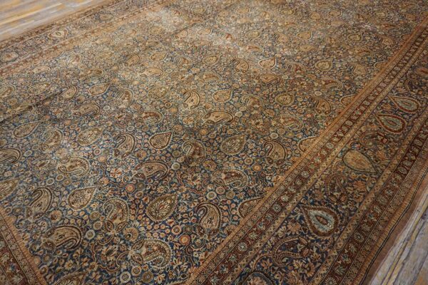Close-up view of a blue and tan oriental rug featuring a dense paisley pattern, by rugs on net. By rugs on net