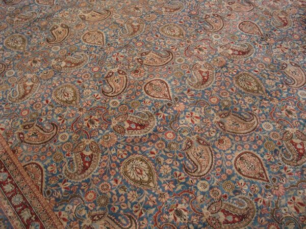 Close-up view of a blue field rug with intricate paisley and floral patterns, by rugs on net