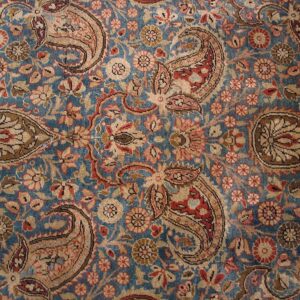 Close-up of a blue field Persian rug with repeating paisley motifs by Rugs On Net