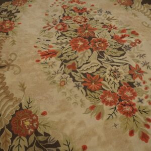 Close-up of a floral rug with orange and green motifs on a beige field, by Rugs On Net