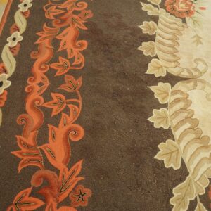 Close-up of a brown and cream floral rug with orange accents by Rugs On Net