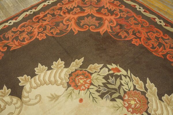 Close-up of a dark brown rug with orange and beige floral borders, by rugs on net