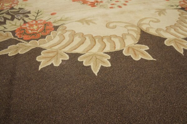Close-up of a floral motif border on a brown rug by rugs on net