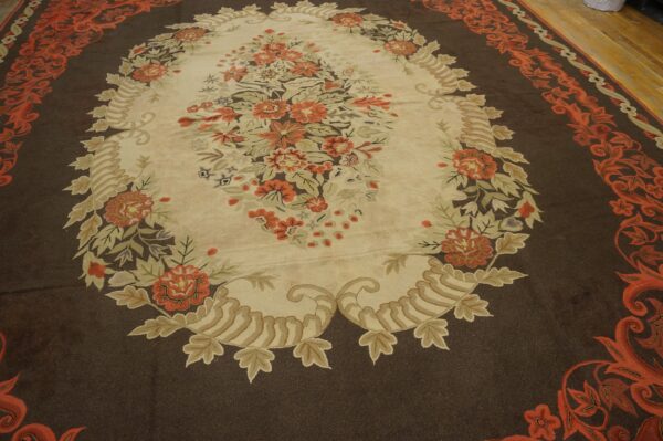 Oval floral rug with orange and cream details on a dark brown field by rugs on net