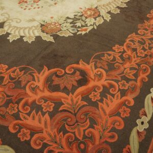 Close-up of a brown rug with vibrant orange floral border design by Rugs On Net. by Rugs On Net