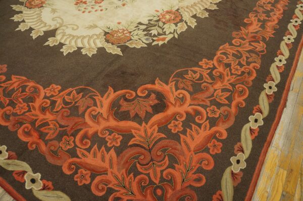 Close-up of a brown rug with vibrant orange floral border design by rugs on net. By rugs on net
