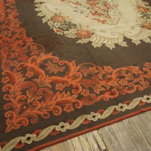 Close-up of a brown rug with vibrant orange floral border design by Rugs On Net. by Rugs On Net