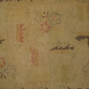 Close-up of a beige hooked rug with faded floral motifs and a dark brown serrated border by Rugs On Net. by Rugs On Net