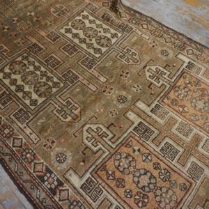 Close-up of a geometric patterned antique rug with brown and muted pink tones by Rugs On Net