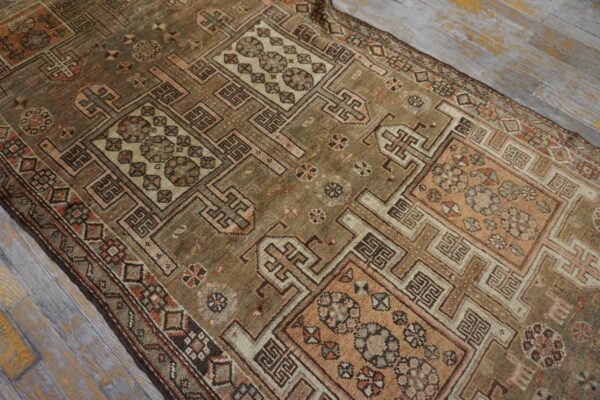 Close-up of a geometric patterned antique rug with brown and muted pink tones by rugs on net
