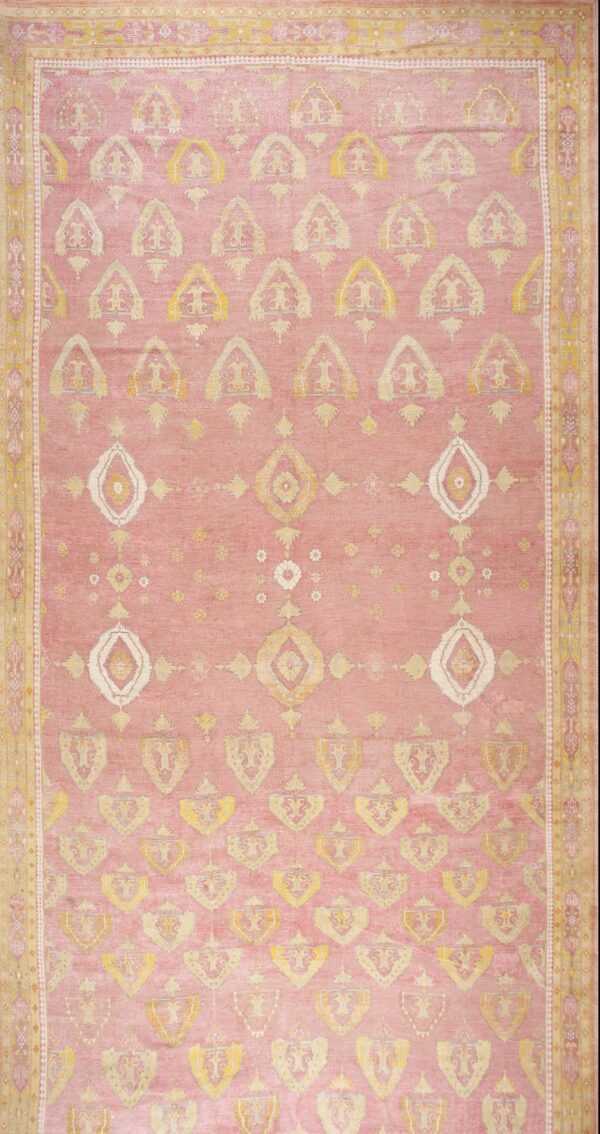 Vintage oversized indian agra salmon and coral hand knotted rug with a dusty rose field carpet by rugs on net