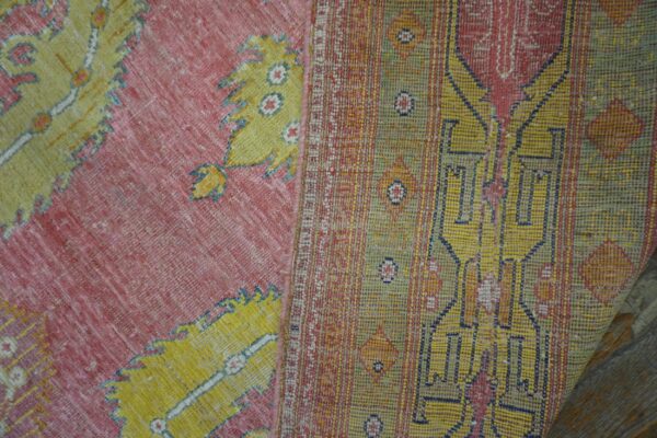 Close-up texture of a pink and yellow vintage rug by rugs on net