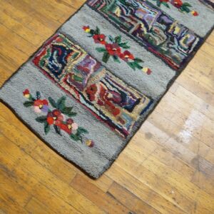 Close-up of a colorful hooked rug runner with floral accents on a wooden floor by Rugs On Net