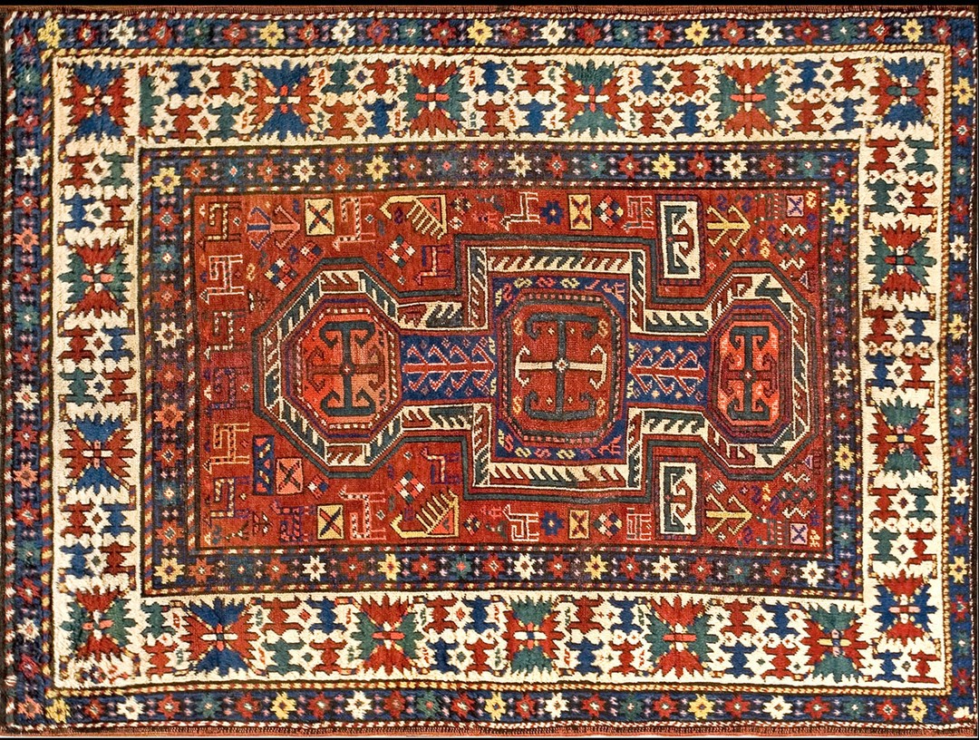 Small antique late 19th century caucasian kazak key hole design rug