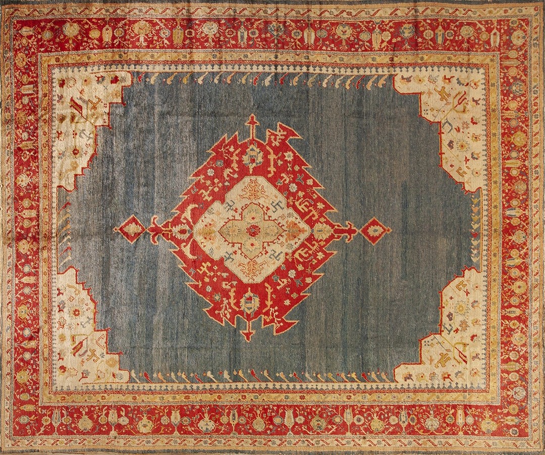 Bold open light blue field tribal antique red medallion design turkish angora oushak rug