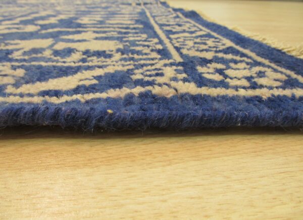 Blue floral rug with brown chair