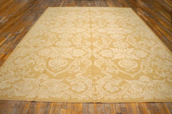 Contemporary handwoven wool needlepoint rug â€” beige-ivory color - detail view 1