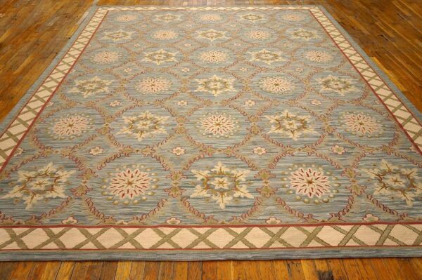 Contemporary handwoven wool needlepoint rug â€” light blue color - detail view 1