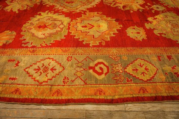 1890s red ground geometric knotted wool antique oushak turkish decorative rug 4 1890s red ground geometric knotted wool antique oushak turkish decorative rug - detail view 3