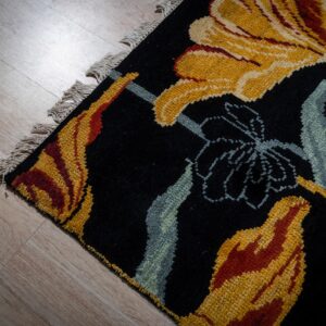 Black floral contemporary rug corner detail with gold blossoms