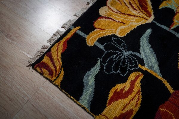 Black floral contemporary rug corner detail with gold blossoms