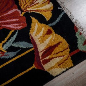 Black floral contemporary rug corner and fringe detail