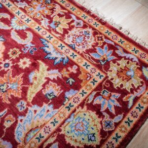 Burgundy Oushak rug corner and border detail