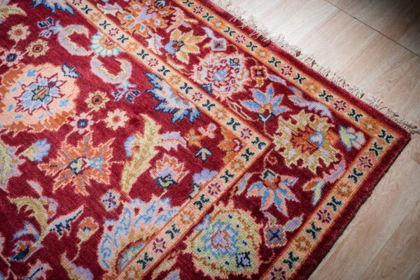 Burgundy oushak rug corner and border detail