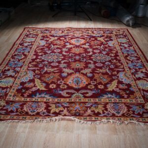 Burgundy Oushak floral wool rug, full view on floor