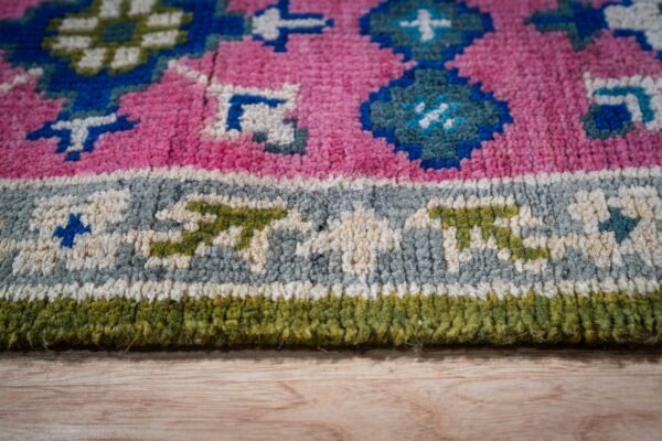 Ava kazak light green hand knotted wool rug 13 Green and fuchsia kazak rug border close-up