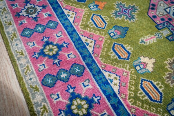 Ava kazak light green hand knotted wool rug 14 Green and fuchsia kazak rug border and field close-up