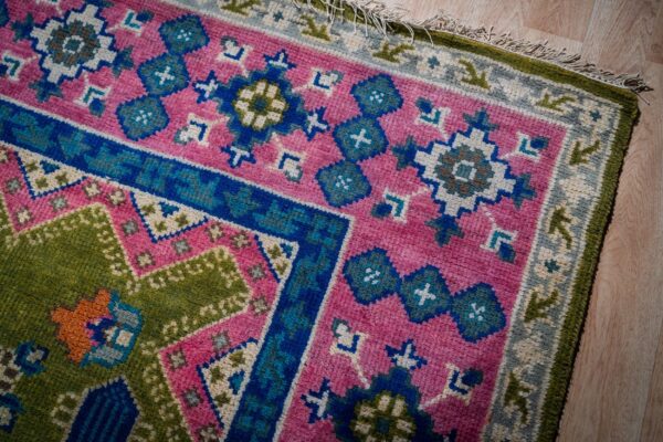 Ava kazak light green hand knotted wool rug 10 Green and fuchsia kazak rug corner and fringe detail