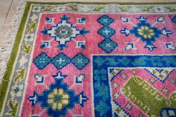 Ava kazak light green hand knotted wool rug 15 Green and fuchsia kazak rug corner pattern detail