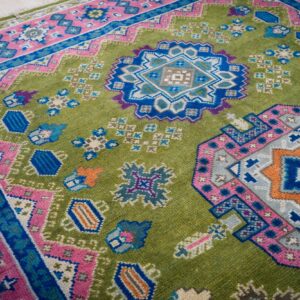 Green and fuchsia Kazak rug medallion detail