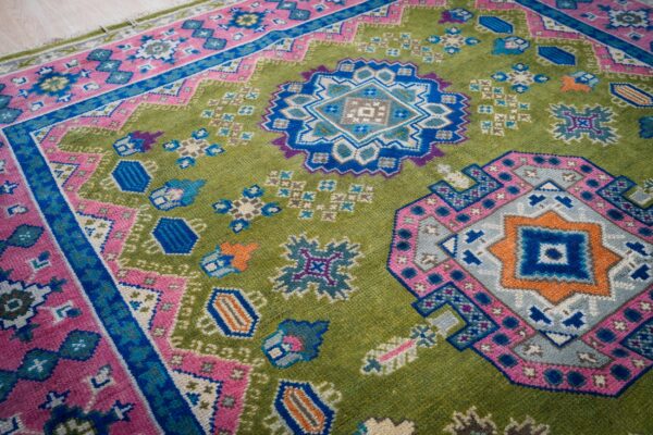 Ava kazak light green hand knotted wool rug 8 Green and fuchsia kazak rug medallion detail
