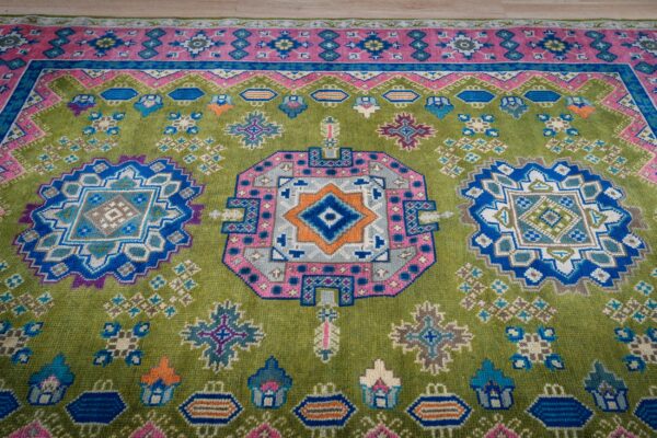 Ava kazak light green hand knotted wool rug 9 Green and fuchsia kazak rug top-down three-medallion detail