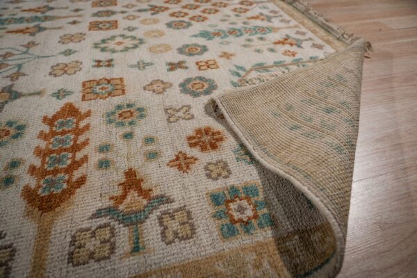 Ivory oushak rug field and hand-knotted back detail