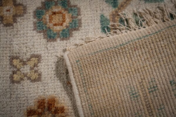 Ivory oushak rug back and fringe detail