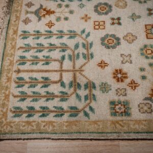 Ivory Oushak rug corner with willow-tree motif