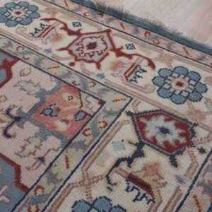 Ivory medallion rug corner and floral border detail