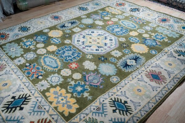 Light green beige kazak hand-knotted rug, angled full view