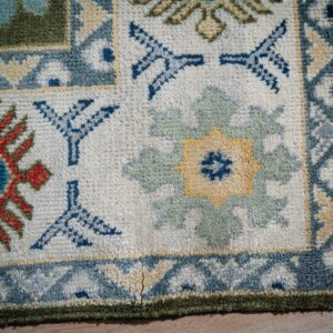 Light green beige Kazak rug corner and border detail