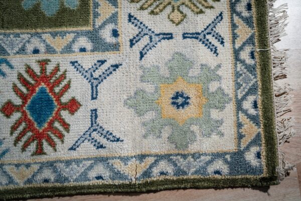 Light green beige kazak rug corner and border detail