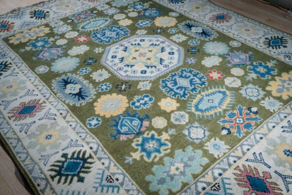 Light green beige kazak rug angled field detail