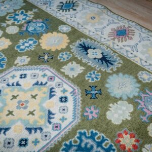 Light green beige Kazak rug central medallion and border detail