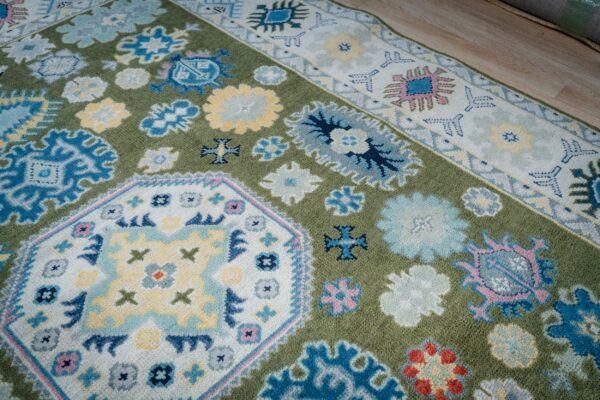 Light green beige kazak rug central medallion and border detail