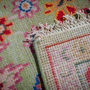 Light green Oushak rug hand-knotted back and fringe detail
