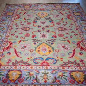 Light green Oushak floral wool rug, angled full view
