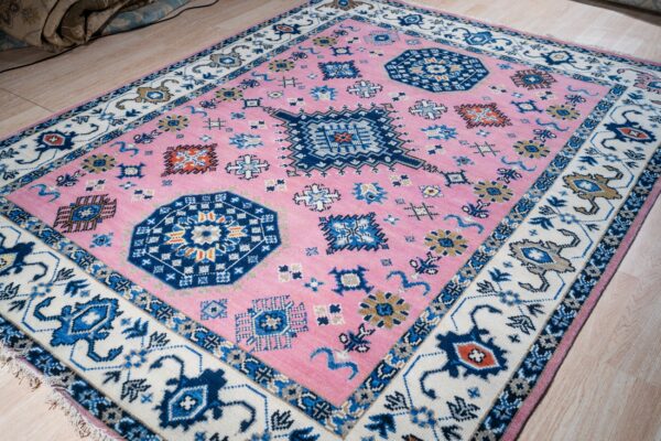 Pink ivory kazak rug angled full view