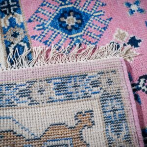 Pink ivory Kazak rug hand-knotted back and fringe detail